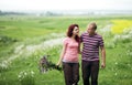 Couple in love guy and girl in a field of white daisies and green grass Royalty Free Stock Photo