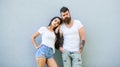 Couple in love hang out together grey wall background. Couple stylish young modern people. Couple white shirts lean each Royalty Free Stock Photo