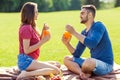 couple in love have fun in the park and drink smoothies and eating fruit at a picnic Royalty Free Stock Photo