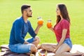 couple in love have fun in the park and drink smoothies and eating fruit at a picnic Royalty Free Stock Photo