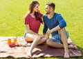 couple in love have fun in the park and drink smoothies and eating fruit at a picnic Royalty Free Stock Photo