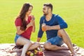 couple in love have fun in the park and drink smoothies and eating fruit at a picnic Royalty Free Stock Photo