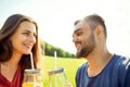 couple in love have fun in the park and drink smoothies and eating fruit at a picnic Royalty Free Stock Photo