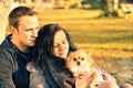 Couple in love having fun with their dog at park - Young people