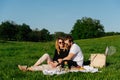 Couple in love having a picnic in a countryside on a green grass Royalty Free Stock Photo