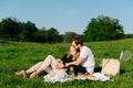 Couple in love having a picnic on a spring grassfield in a countryside Royalty Free Stock Photo
