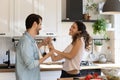 Couple in love holding hands dancing in kitchen at home Royalty Free Stock Photo