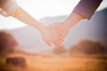 Loving couple holding hands in nature at sunset Royalty Free Stock Photo