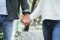 Couple in love holding hands and walking together in outdoor romantic leisure activity together. Close up of man and woman keeping Royalty Free Stock Photo