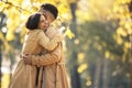 Couple in love hugging on autumn park, enjoying a beautiful autumn day Royalty Free Stock Photo