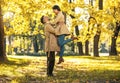 Couple in love hugging on autumn park, enjoying a beautiful autumn day Royalty Free Stock Photo