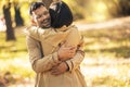 Couple in love hugging on autumn park, enjoying a beautiful autumn day Royalty Free Stock Photo