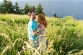 couple in love hugging in big green grass. Couple in love passionately hugging. Long-awaited meeting of the two lovers in grass Royalty Free Stock Photo