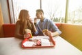 Couple in love hugging having fun, laughing and smiling together. Handsome boyfriend joke of her girlfriend and feed her, french f Royalty Free Stock Photo