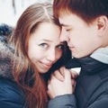 Couple in love hugging and having fun in winter forest