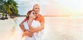 Couple in love hugging on the sandy exotic beach while they have a evening walk by the Trou-aux-Biches seashore on Mauritius Royalty Free Stock Photo