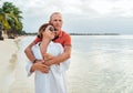 Couple in love hugging on the sandy exotic beach while they have a evening walk by the Trou-aux-Biches seashore on Mauritius Royalty Free Stock Photo