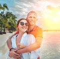 Couple in love hugging on the sandy exotic beach while they have a evening walk by the Trou-aux-Biches seashore on Mauritius