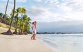 Couple in love hugging on sandy exotic beach while having evening walk by Trou-aux-Biches seashore on Mauritius island enjoying Royalty Free Stock Photo