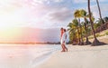 Couple in love hugging on sandy exotic beach while having evening walk by Trou-aux-Biches seashore on Mauritius island enjoying Royalty Free Stock Photo