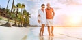 Couple in love hugging while walking on a sandy exotic beach. They have an evening walk by Trou-aux-Biches seashore on Mauritius