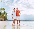 Couple in love hugging while walking on a sandy exotic beach. They have an evening walk by Trou-aux-Biches seashore on Mauritius Royalty Free Stock Photo