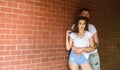 Couple in love hugs brick wall background. Couple find place to be alone. He will never let her go. Girl and hipster Royalty Free Stock Photo