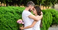 Couple in love hugs on date in park green bushes background. Man fall in love with gorgeous girl. Man bearded hipster Royalty Free Stock Photo