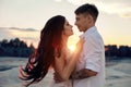 Couple in love hugs kiss happy life, man and woman, the sunset, the sun rays, a couple in love looking each other in the eye. Royalty Free Stock Photo
