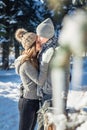 Couple in love hugs and walks in winter forest Royalty Free Stock Photo
