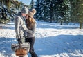 Couple in love hugs and walks in winter forest Royalty Free Stock Photo