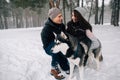 Couple in love with Husky dog in winter forest Royalty Free Stock Photo