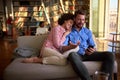 Couple in love indoor looking in cell phone