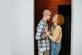 Couple in love inside an apartment under construction, looking at each other