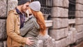 Couple, love and kiss with smile in outdoor or against wall in cold weather, together and support in London Royalty Free Stock Photo