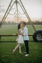 Couple in love kisses under water drops from agricultural sprayer Royalty Free Stock Photo