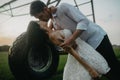 Couple in love kisses under water drops from agricultural sprayer Royalty Free Stock Photo