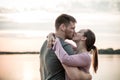 Couple in love kissing at the beach in the sunset Royalty Free Stock Photo