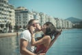 Couple in love kissing on seafront. Happy family spend time together, hug and kiss, sea and urban background. Family Royalty Free Stock Photo