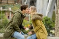 Couple in love kissing tenderly on street celebrating Valentines day or anniversary cheering in Champagne Royalty Free Stock Photo