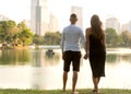 Couple in love laughing looking at each other in the Bangkok park  and tropical threes Royalty Free Stock Photo