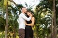 Couple in love laughing looking at each other in the Bangkok park  and tropical threes Royalty Free Stock Photo