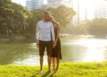 Couple in love laughing looking at each other in the Bangkok park  and tropical threes Royalty Free Stock Photo