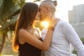 Couple in love laughing looking at each other in the Bangkok park  and tropical threes Royalty Free Stock Photo