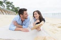 couple in love laying on sand on beach Royalty Free Stock Photo