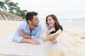 couple in love laying on sand on beach