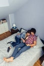 Couple in love looking electronic tablet on bed