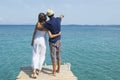 Couple in love looking at the sea from a dock