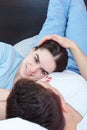 Couple in love lying on bed in bedroom at morning