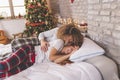 Couple cuddling after waking up on Christmas morning Royalty Free Stock Photo